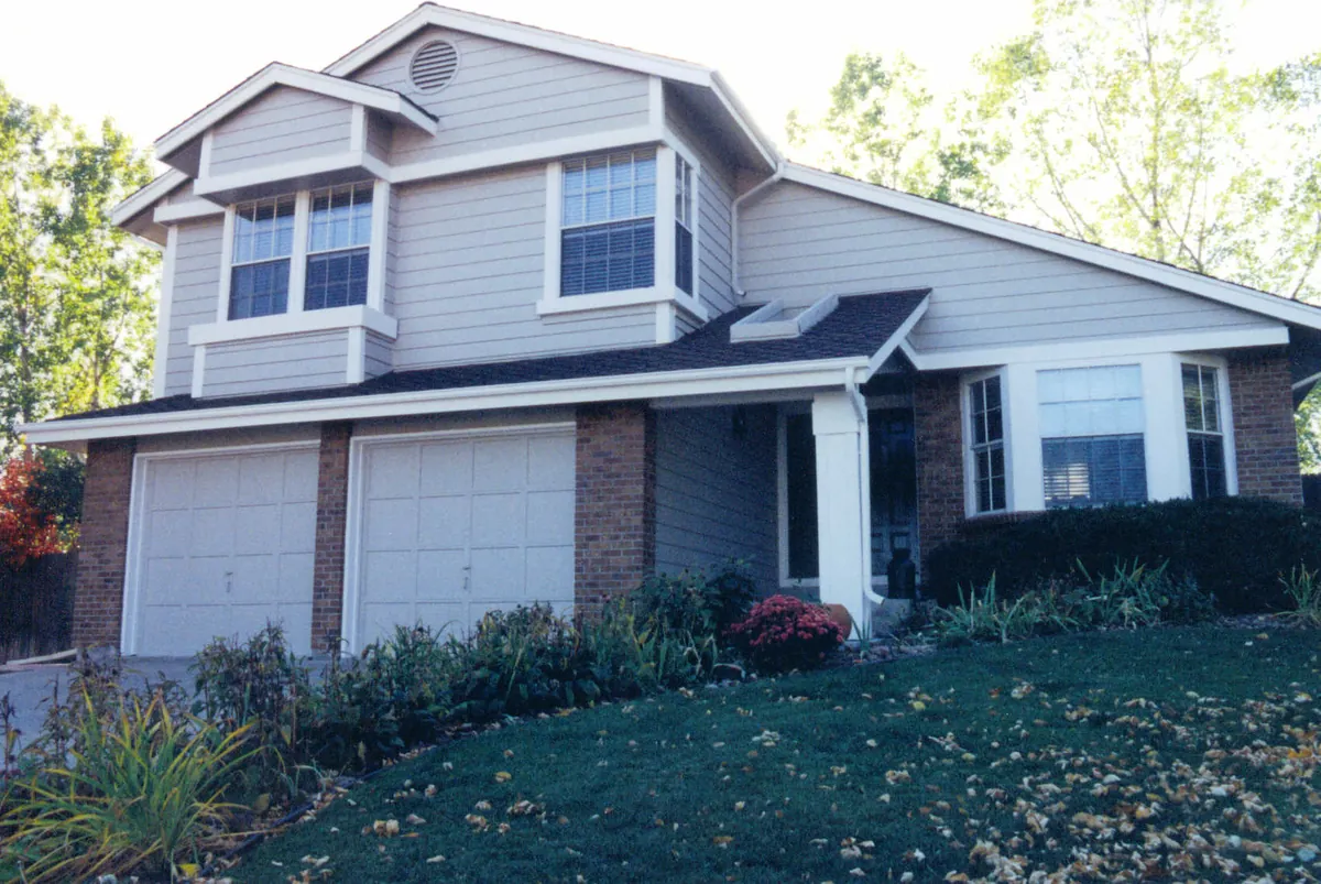 Two-story home with brick base — after