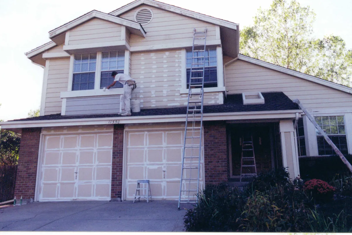 Two-story home with brick base — before