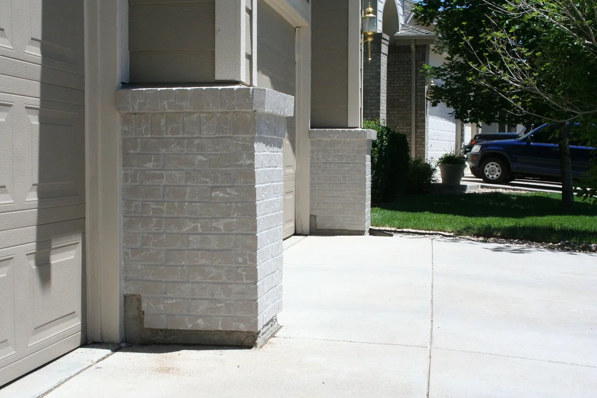 Brick column base after faux finishing to match the stone