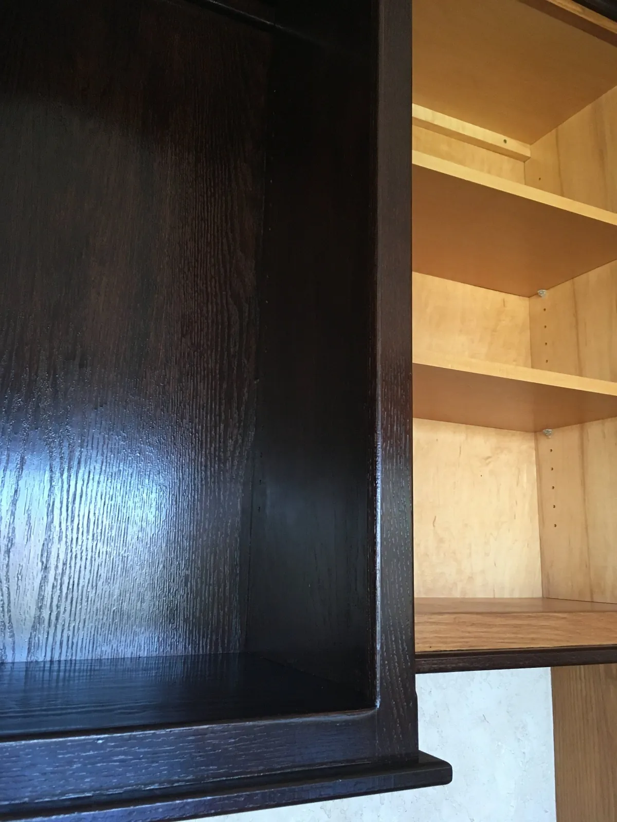 Gel-stained cabinet interior in deep brown