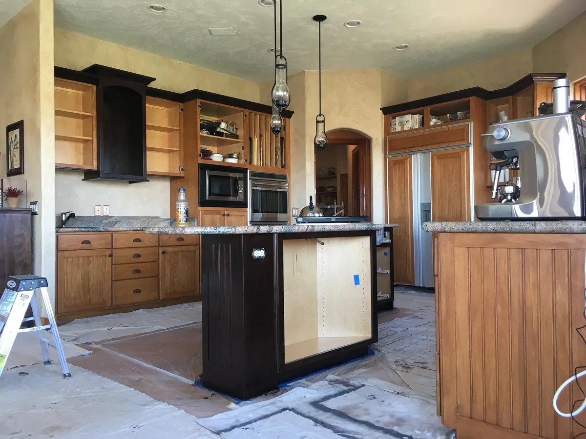 Kitchen cabinetry mid-refinish with island in espresso