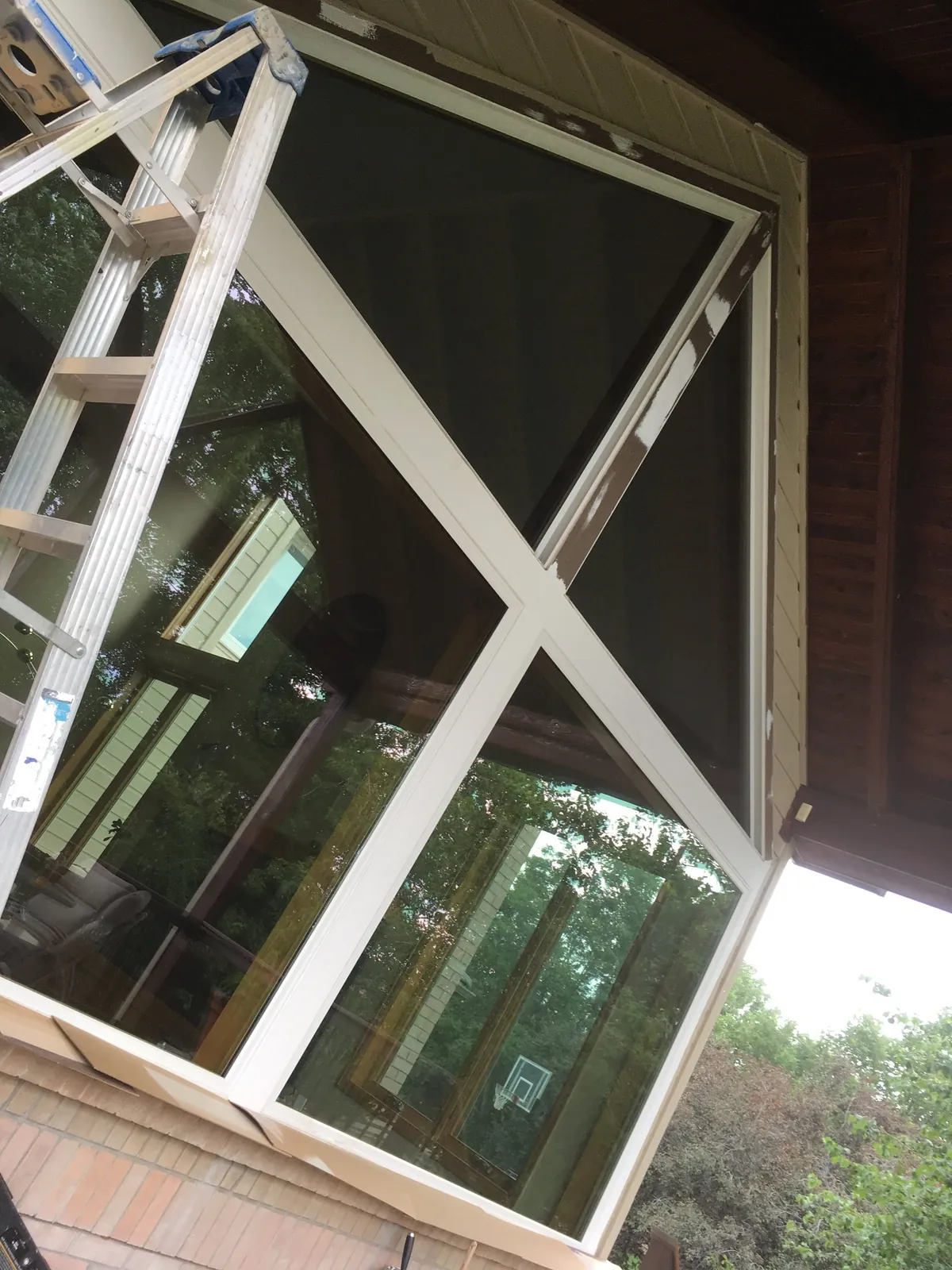 Exterior prep: ladders and masking on a two-story home
