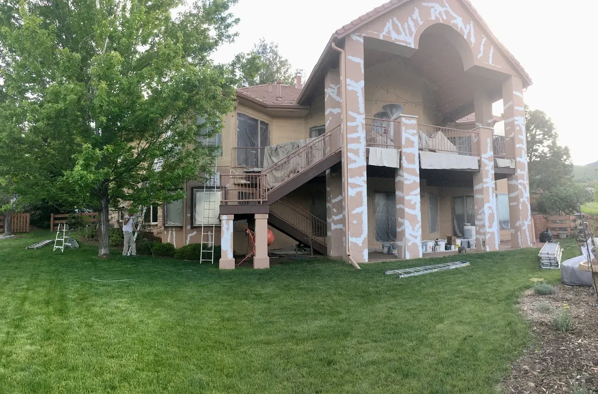 Stone and stucco home with refinished decks