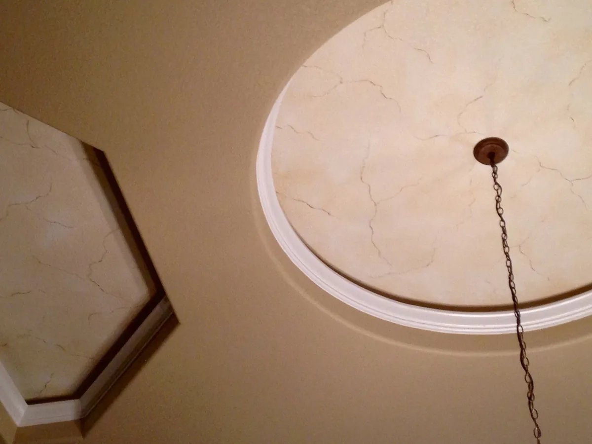 Marbled ceiling medallion inside a tray ceiling