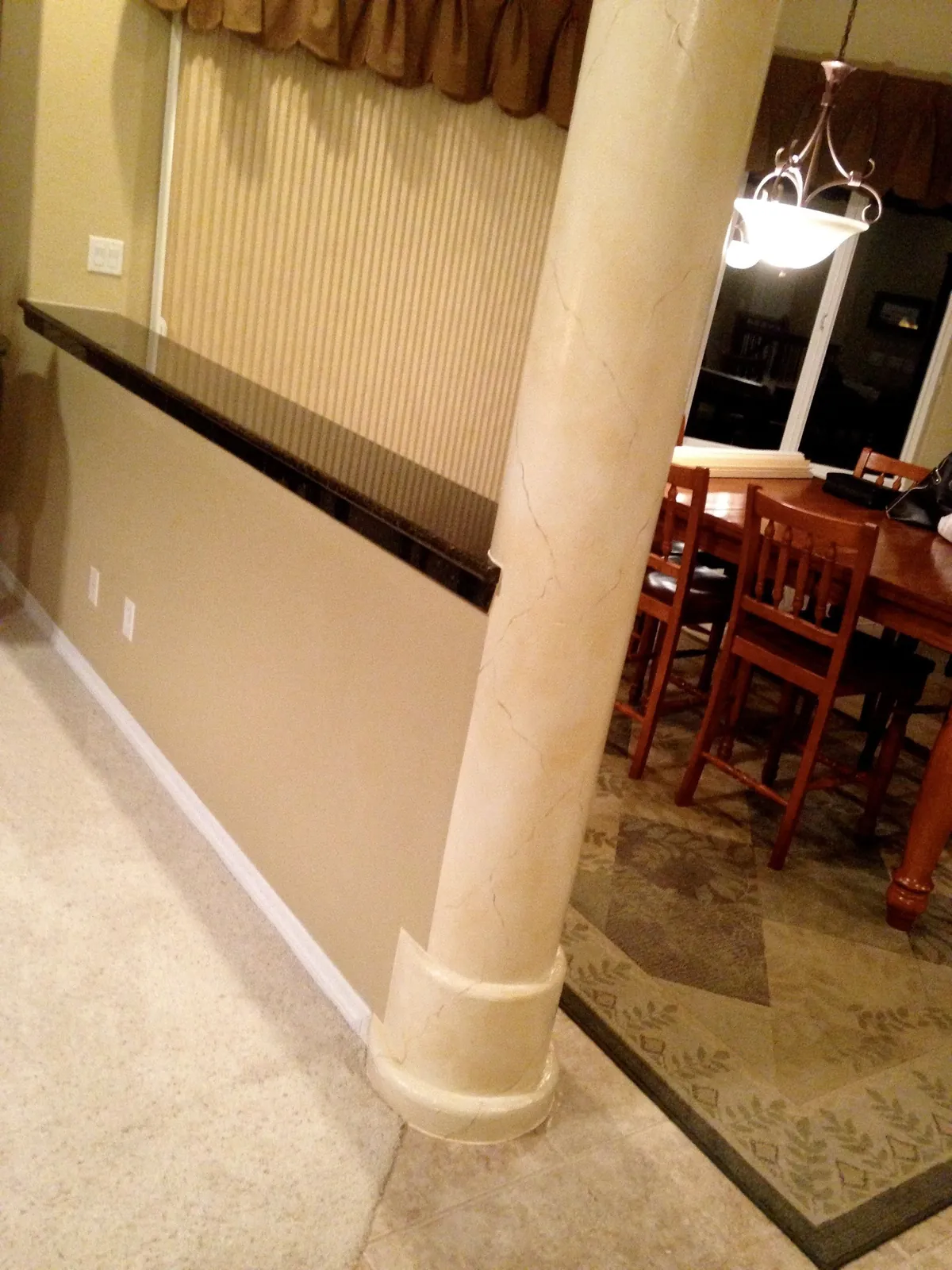 Cream faux marble column in an open living space