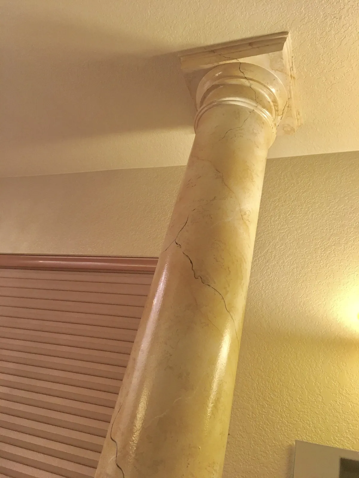 Golden marbled column against a cream wall