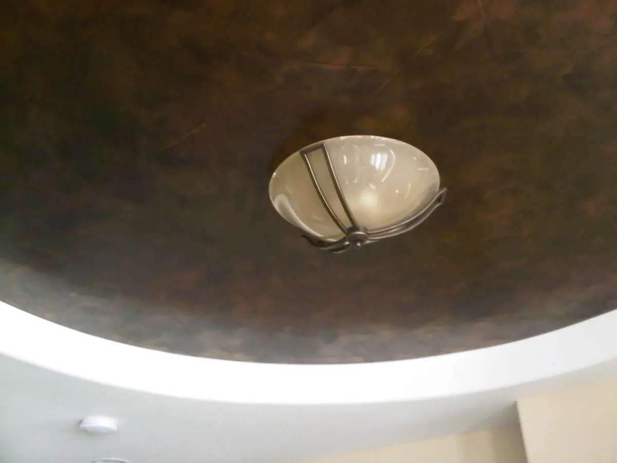 Copper metallic dome ceiling with a pendant fixture