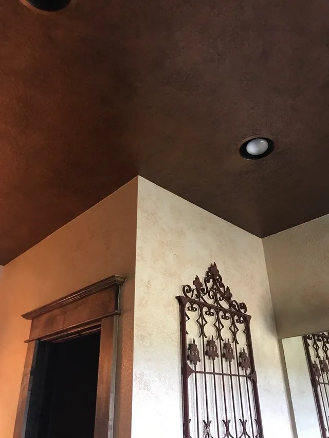 Dark glazed ceiling above a cream patina wall