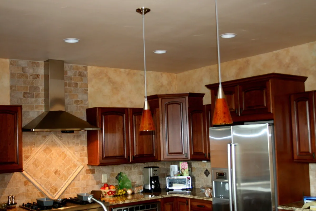 Tuscan kitchen glaze with copper pendant lights