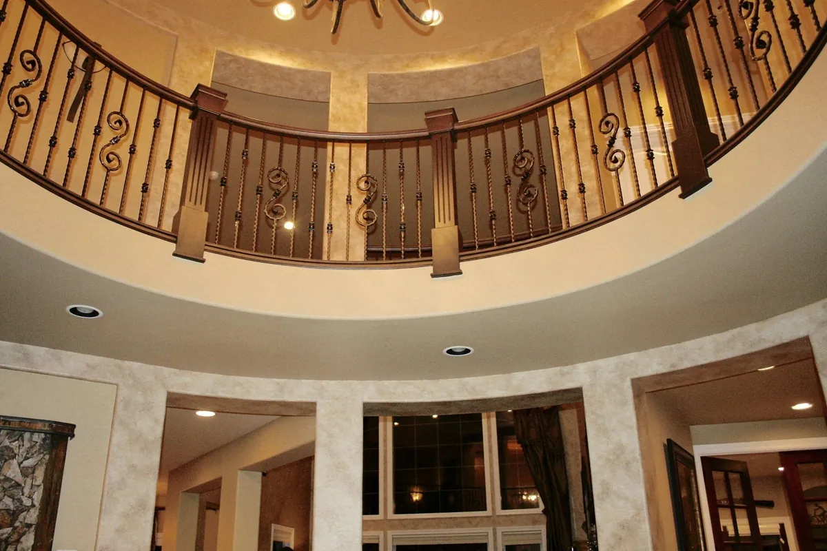 Glazed rotunda walls beneath a wrought iron balcony