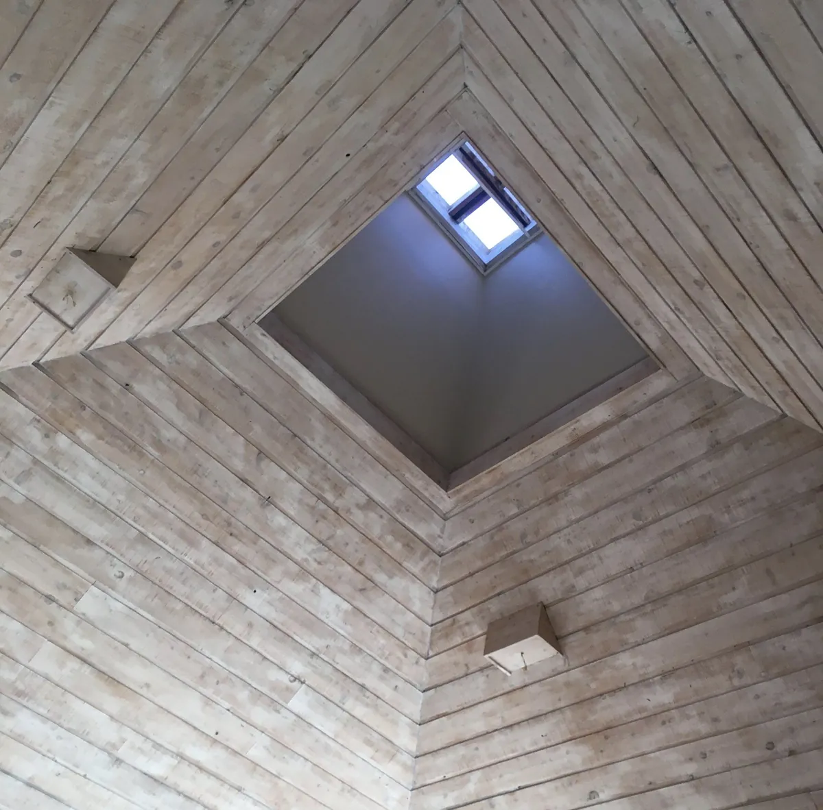 Faux whitewashed plank ceiling around a skylight