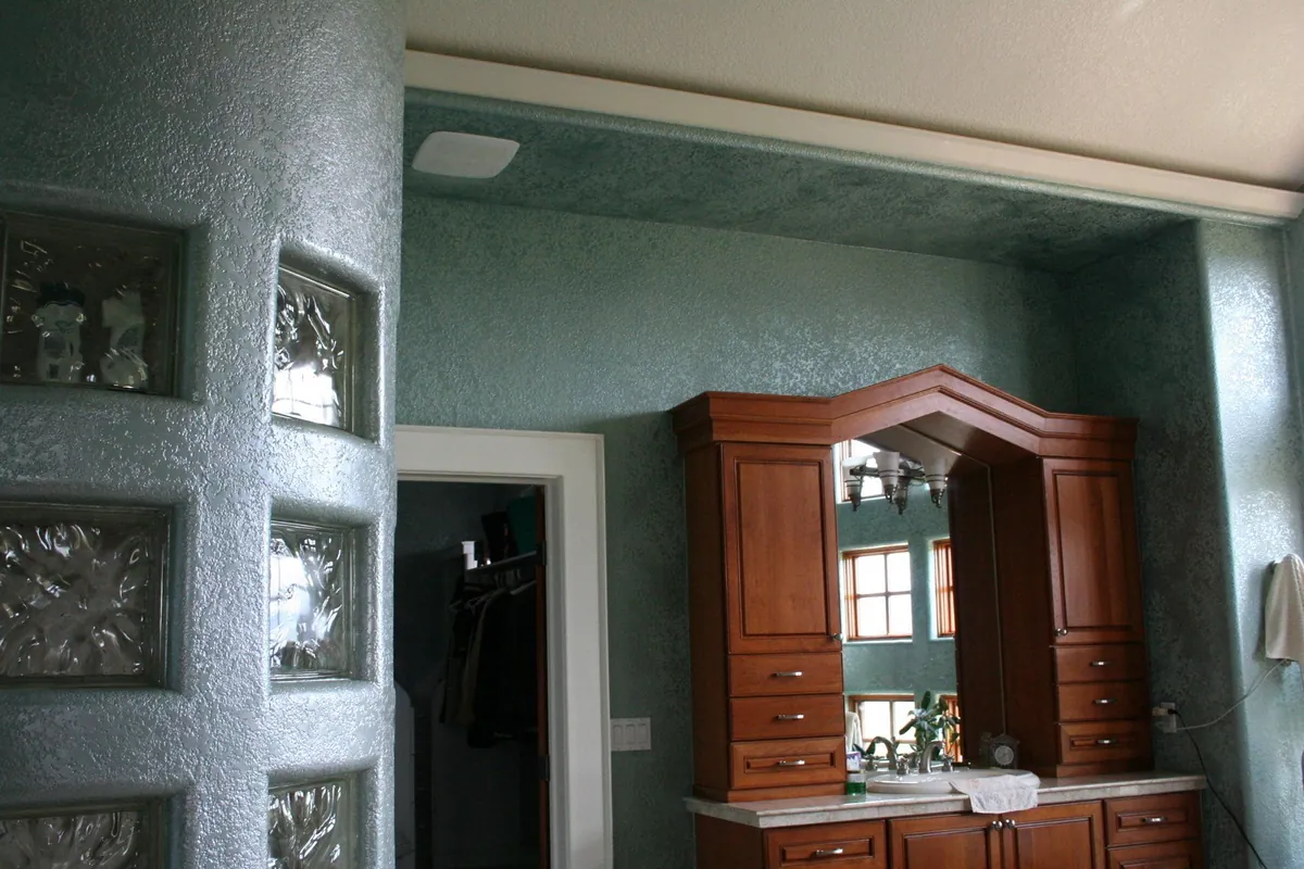 Teal glazed walls framing a cherry built-in