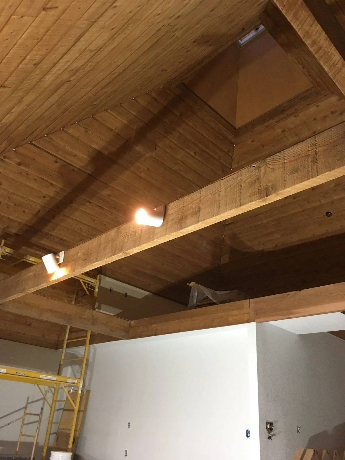 Painted faux wood plank ceiling with beams