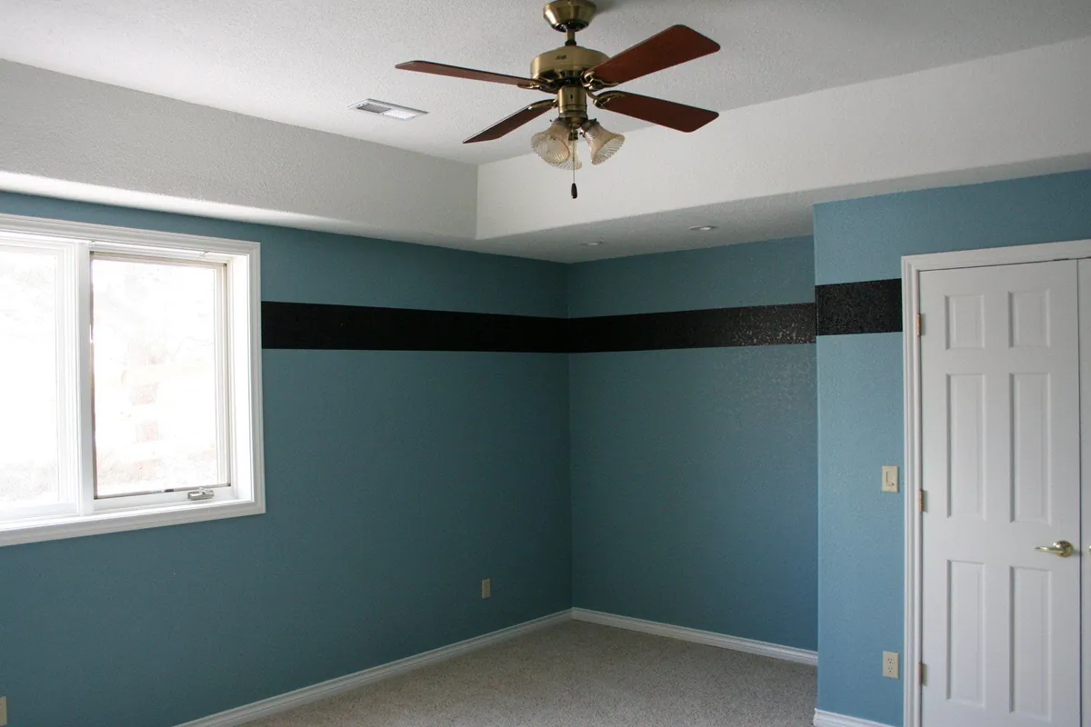 Blue bedroom with a dark accent band