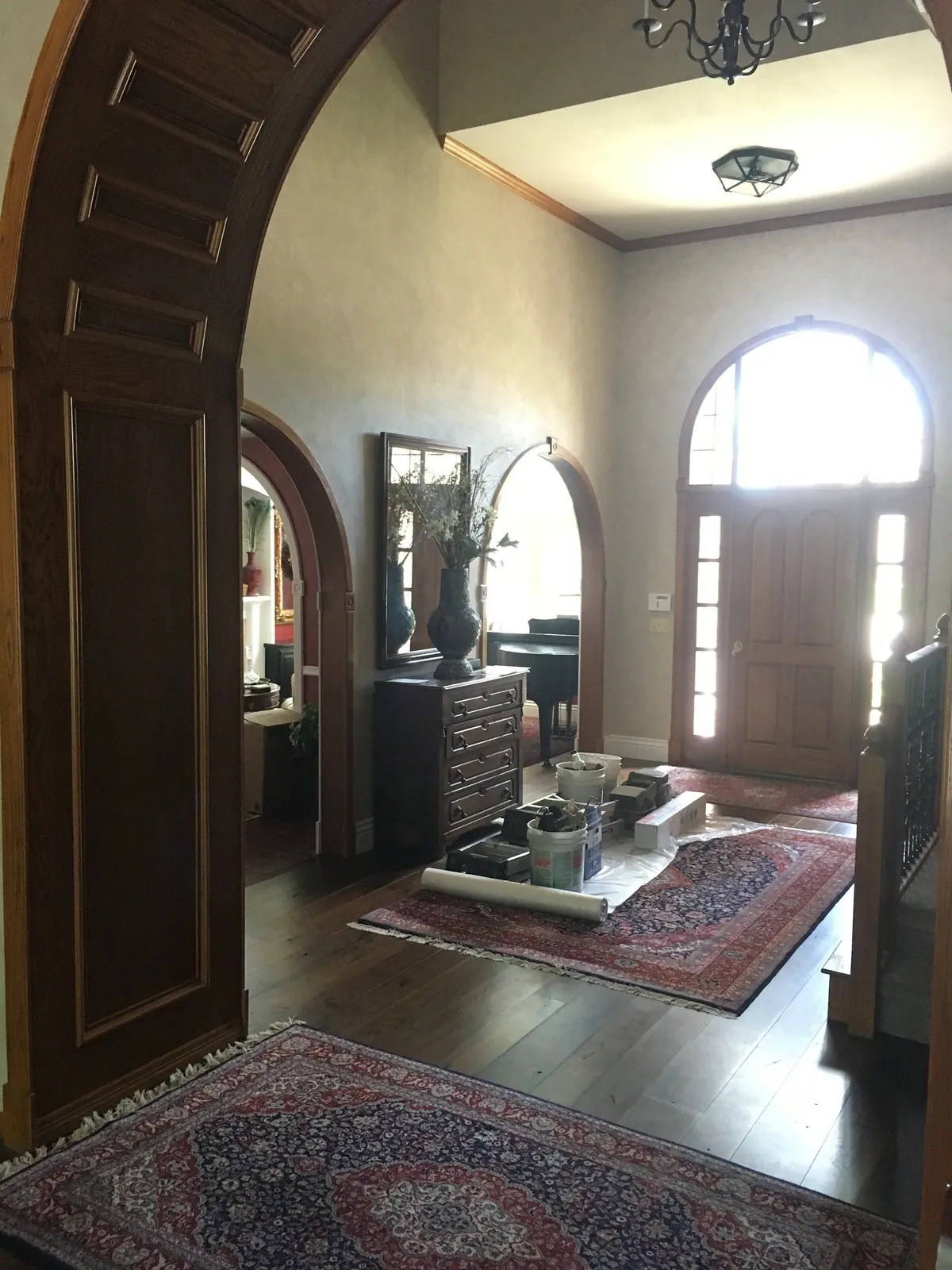 Arched entry with ebonized trim and glazed walls