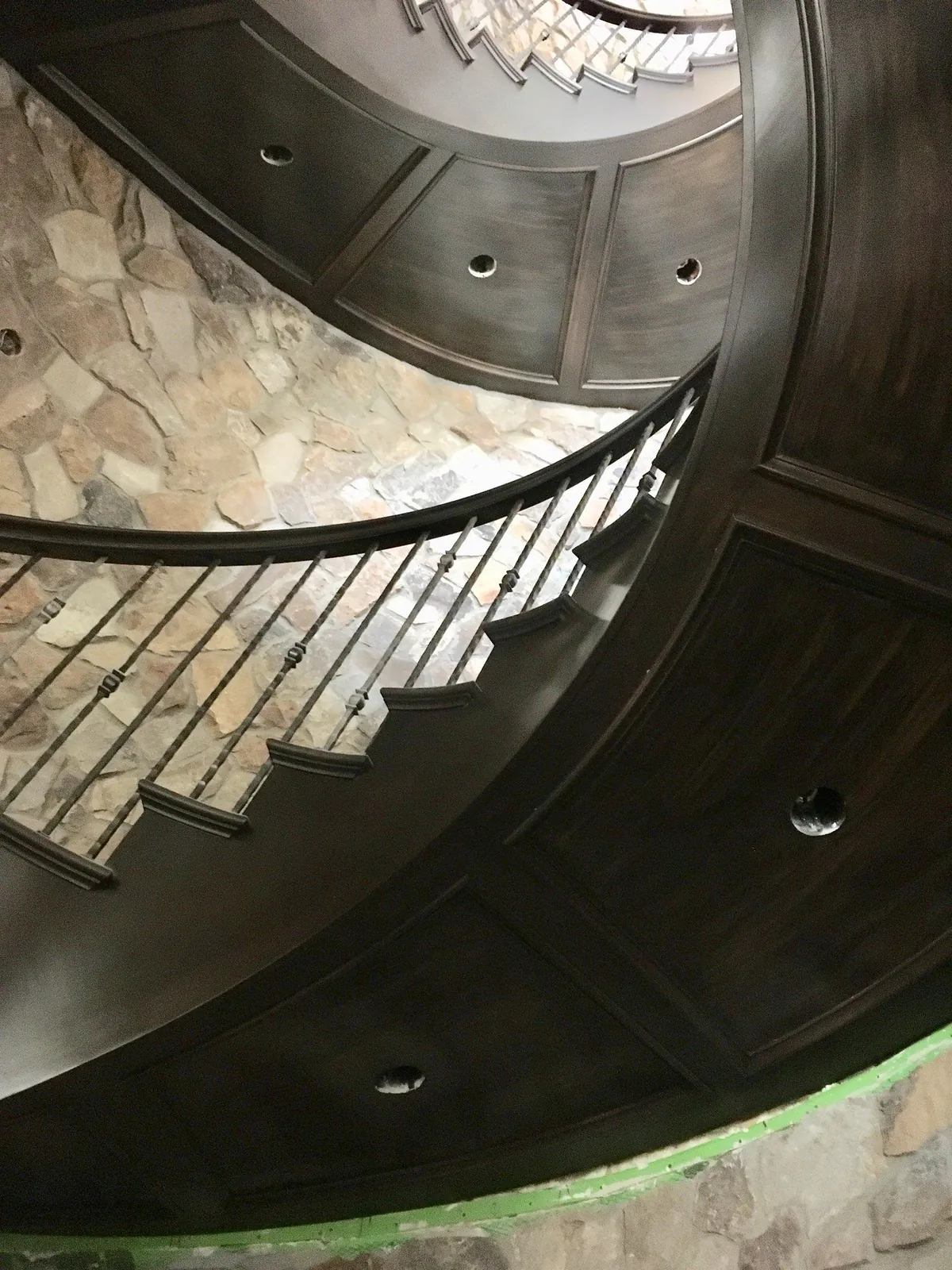 Looking down a refinished spiral staircase