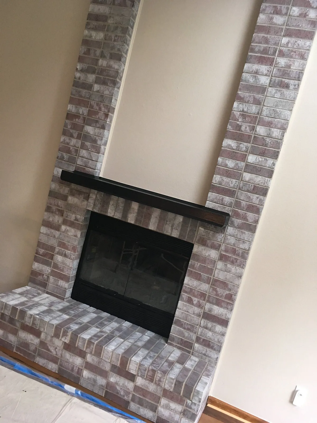 Fireplace brick limewashed with a black mantel